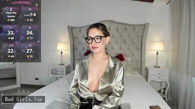 Busty MILF In Glasses Teases Her Cleavage In Shiny Satin