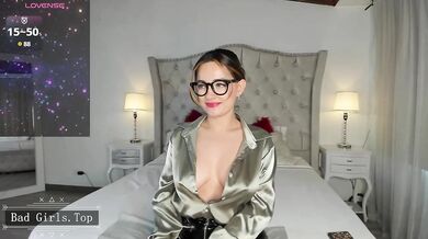 Busty MILF In Glasses Teases Her Cleavage In Shiny Satin