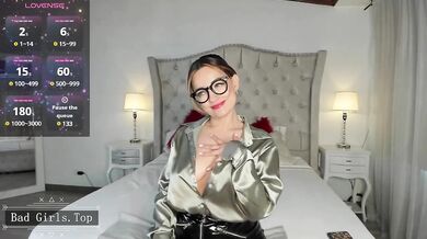 Busty MILF In Glasses Teases Her Cleavage In Shiny Satin