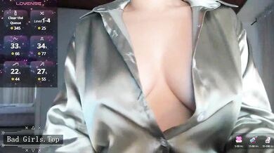 Busty MILF In Glasses Teases Her Cleavage In Shiny Satin