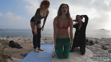 Three Gorgeous Girls Doing Naked Yoga On Rocky Beach At Sunset