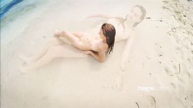 Teen brunette naked on a public beach