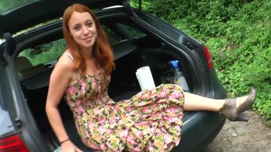Redhead enjoys masturbation in trunk
