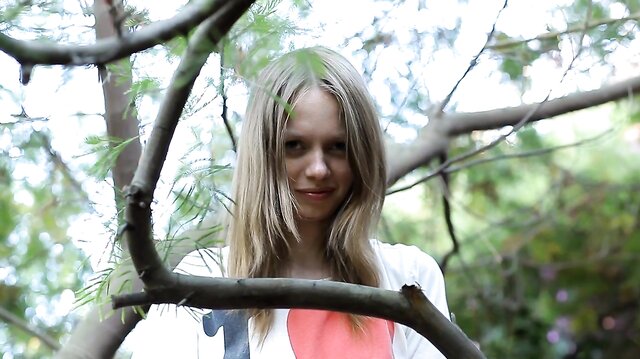 Teen plays with her pussy in tree